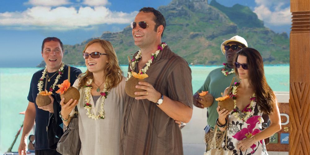 Dave, Ronnie, Joey, and Lucy enjoy tropical drinks by the beach in Couples Retreat