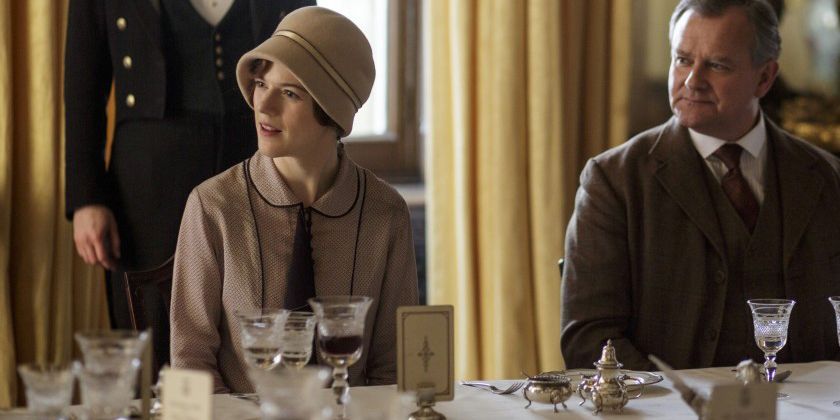 Gwen and Robert sit at the dinner table in Downton Abbey.