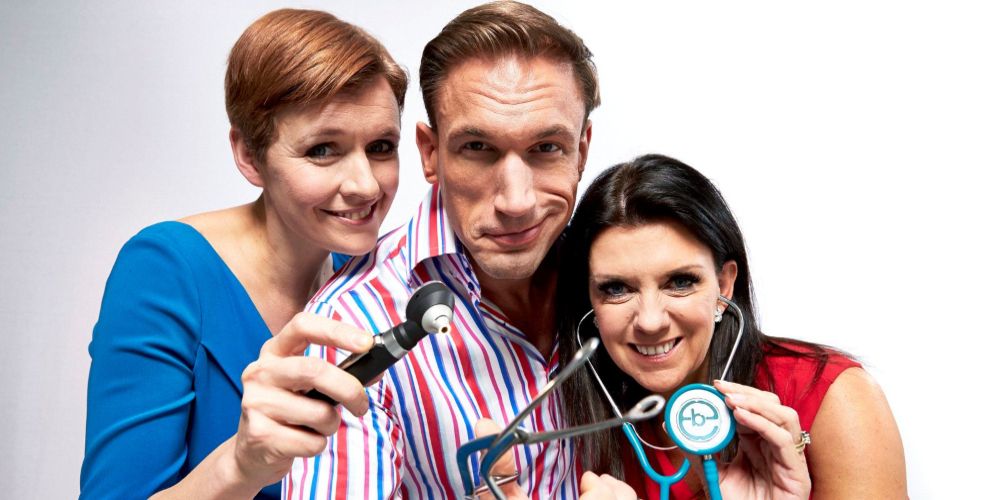 The hosts hold up stethoscope and saw for Embarrassing Bodies promo photo
