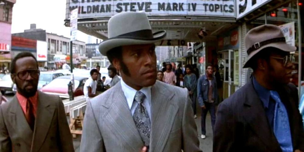 Tommy Gibbs walks down a New York street in Black Caesar