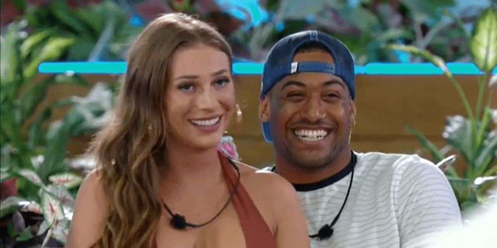 Olivia and Javonny smiling on couch together in Love Island 3
