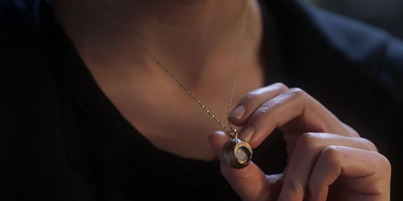 Close up of Chloe holding the necklace Lucifer gave her.