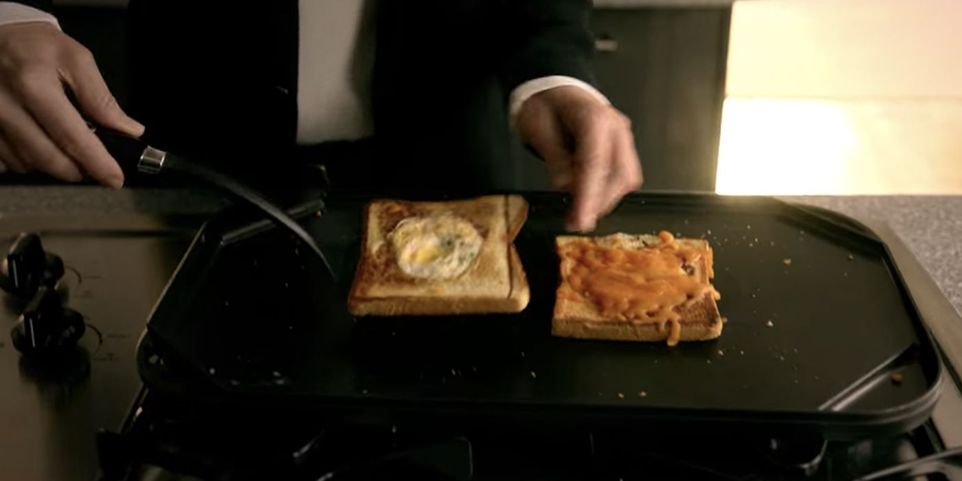 A close-up of Lucifer making egg-in-the-hole grilled cheese for Chloe.