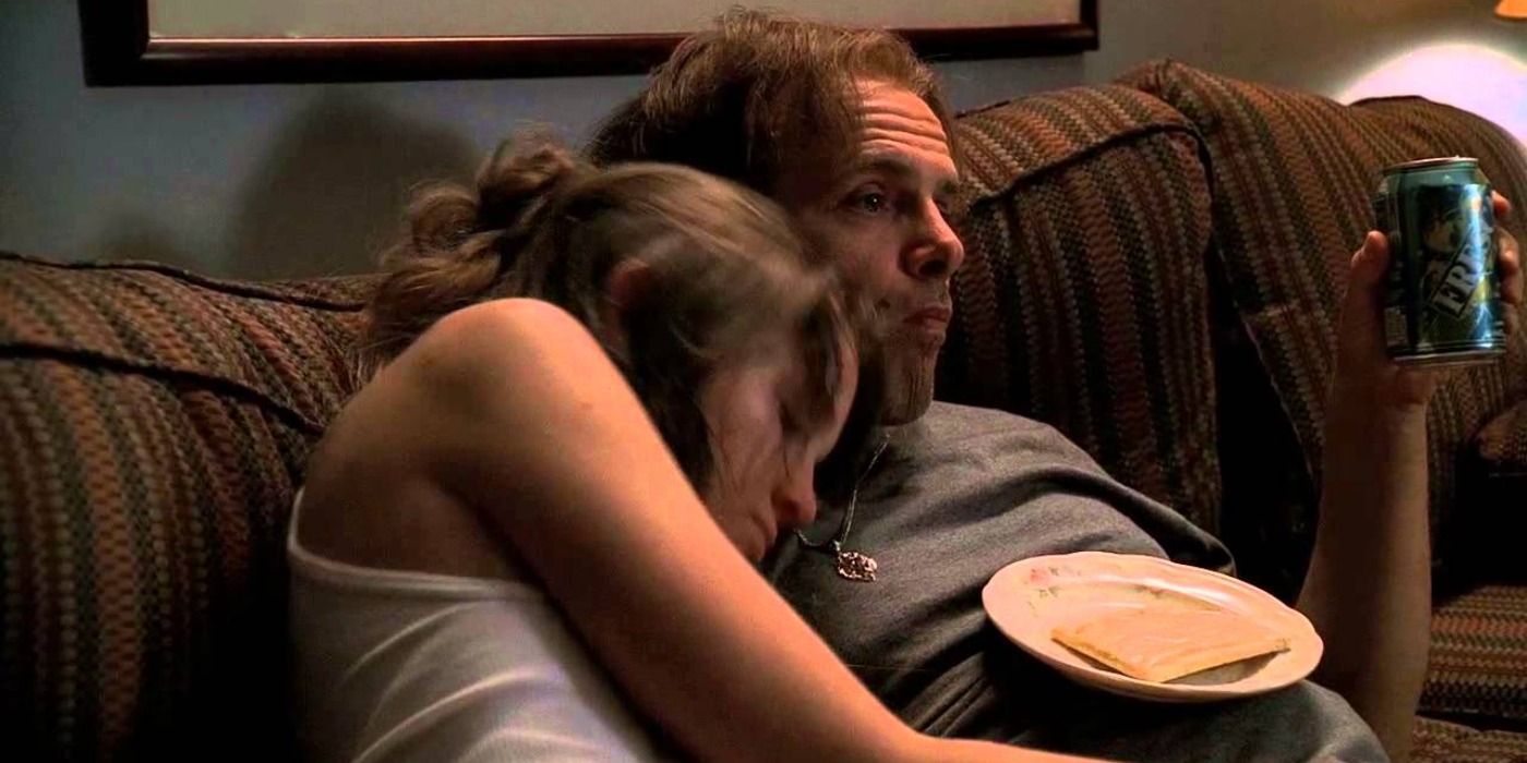 Ralphie sits with Tracee on a couch in The Sopranos.