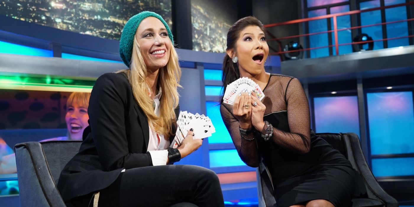 Vanessa and Julie Chen holding cards in Big Brother