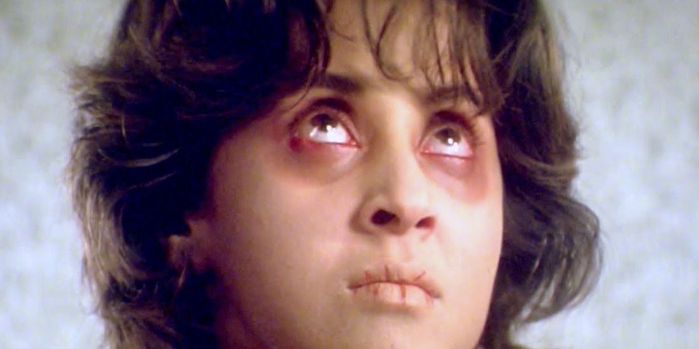 A possessed woman in Bhoot looking up with red eyes.