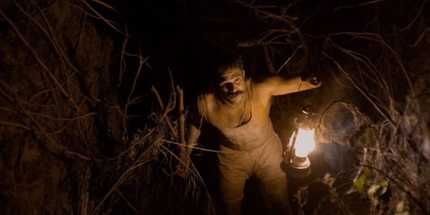 A man holding a lantern in the horror film, Tumbbad.