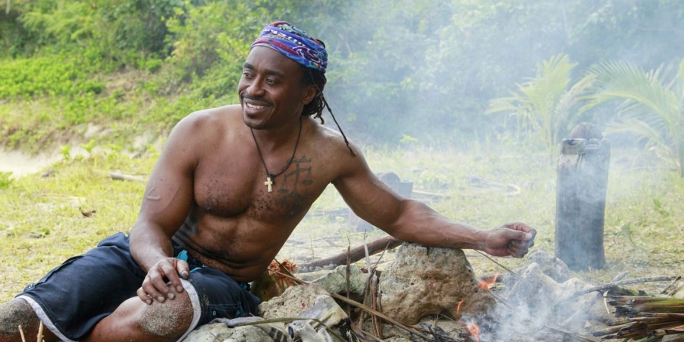 Russell Swan holding his hand over a fire in Survivor