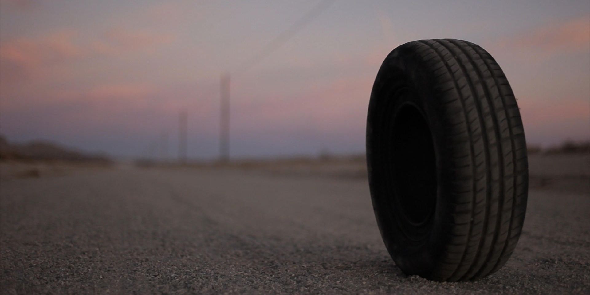 A tire sitting on a deserted road