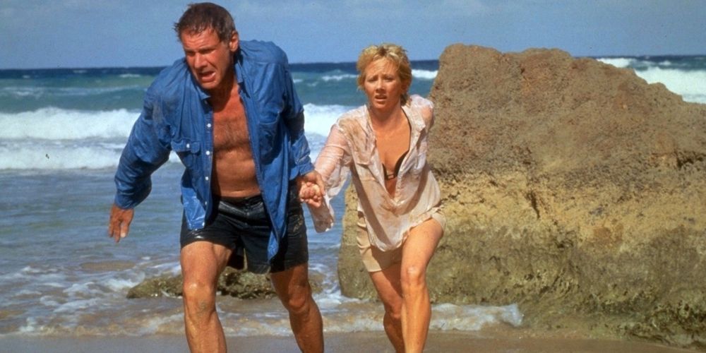 Quinn holds Robin&rsquo;s hand as they walk onto the beach in Six Days Seven Nights