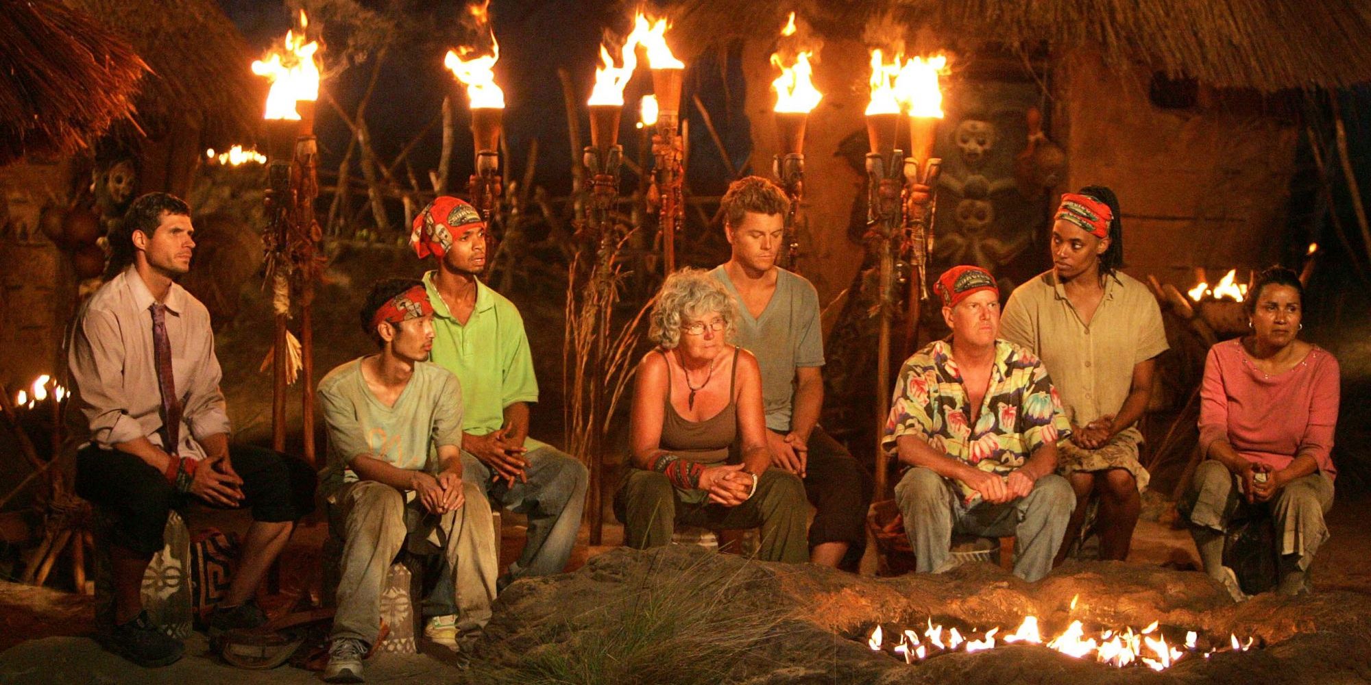 The Fang tribe looks dejected at tribal council on Survivor: Gabon