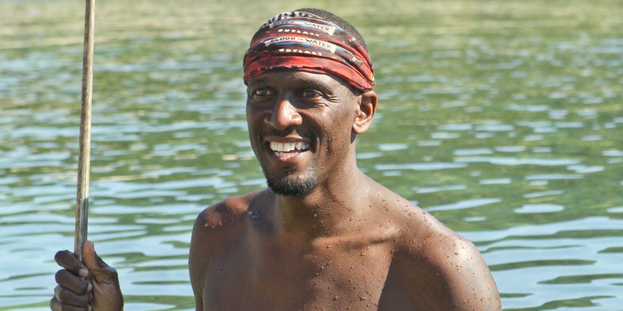 Gervase Peterson stands in the water smiling on Survivor: Blood vs. Water