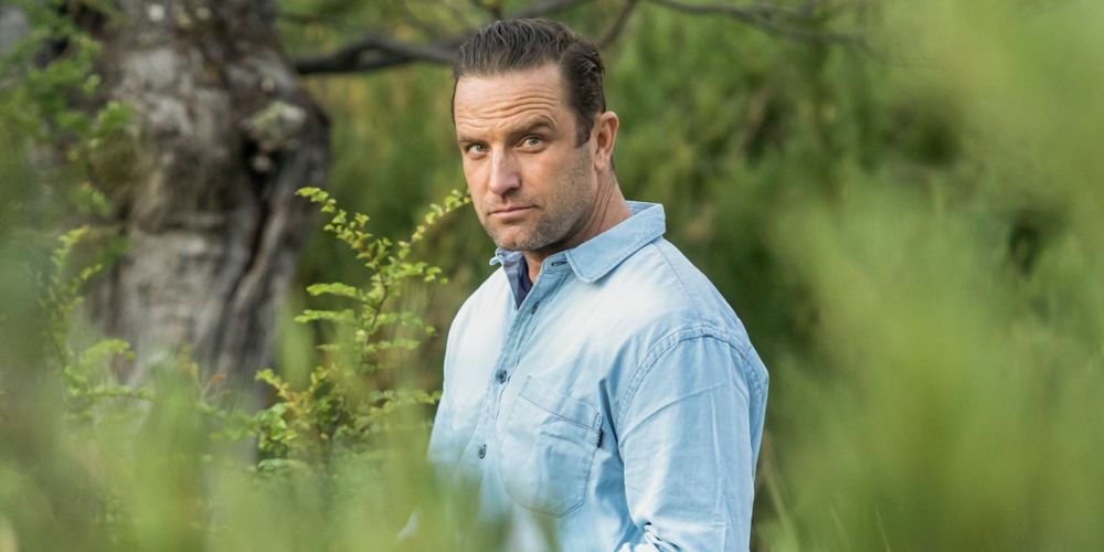 TJ Lavin poses in the woods for The Challenge promo.