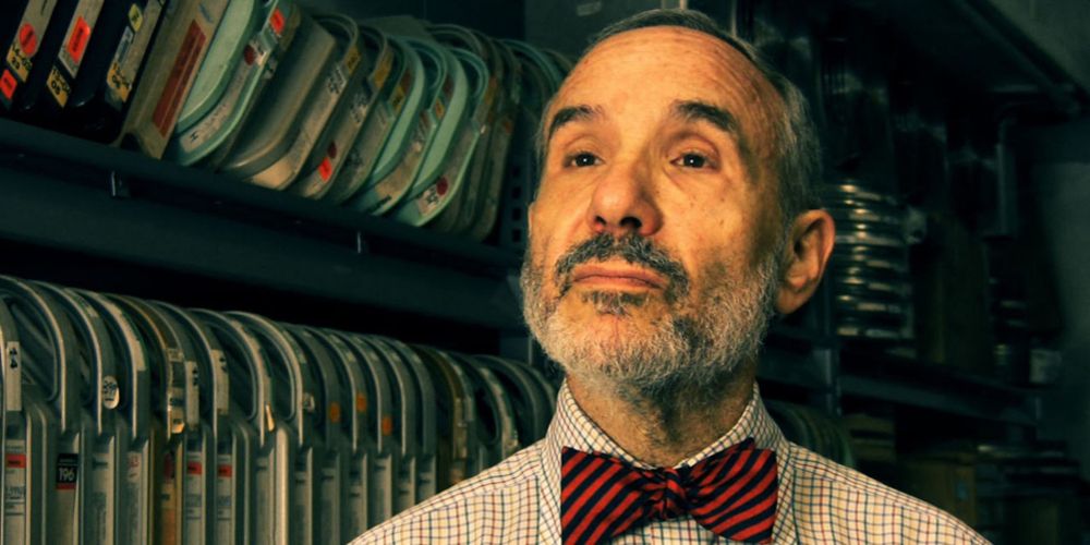 Lloyd Kaufman poses in front of film canisters for Troma's Edge TV