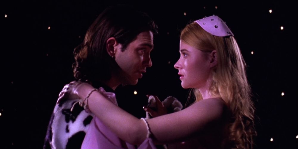 Tromeo and Juliet embrace before a starry backdrop in Tromeo and Juliet