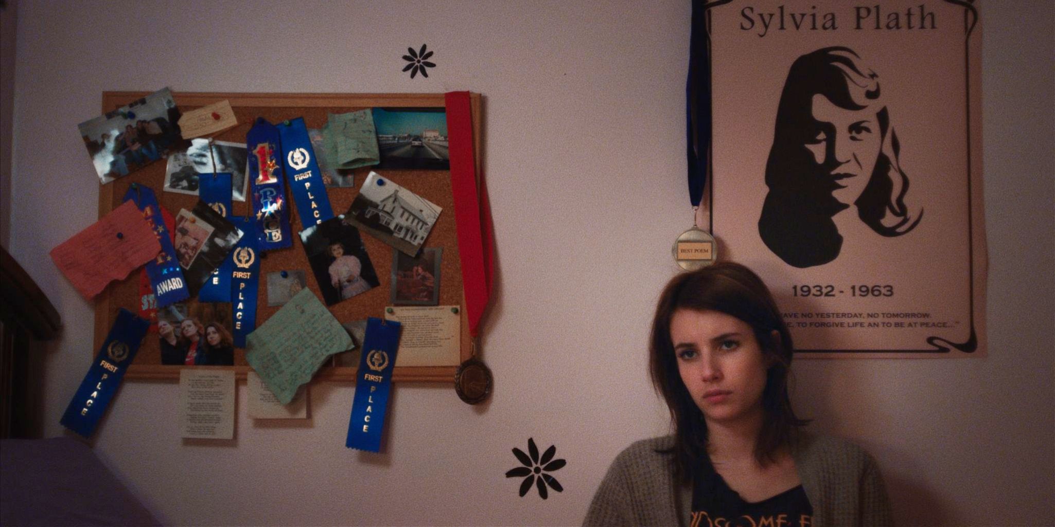 Emma Roberts sits forlornly on her bed in the film Adult World.