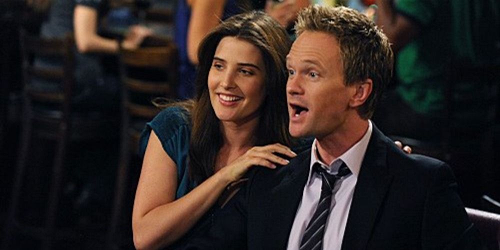 An image of Robin and Barney laughing in How I Met Your Mother