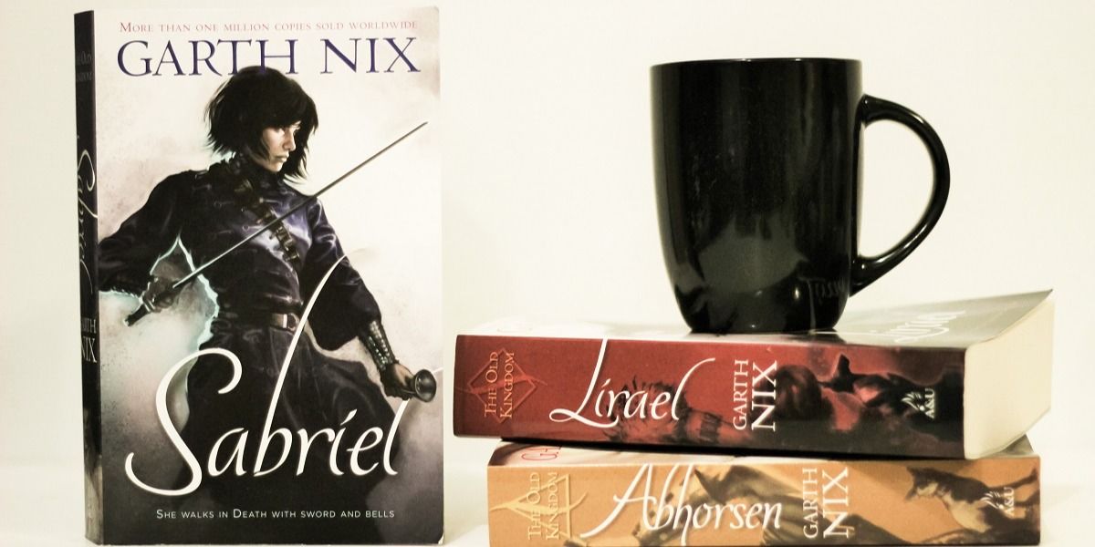 An image of the Sabriel books with a mug on top of them