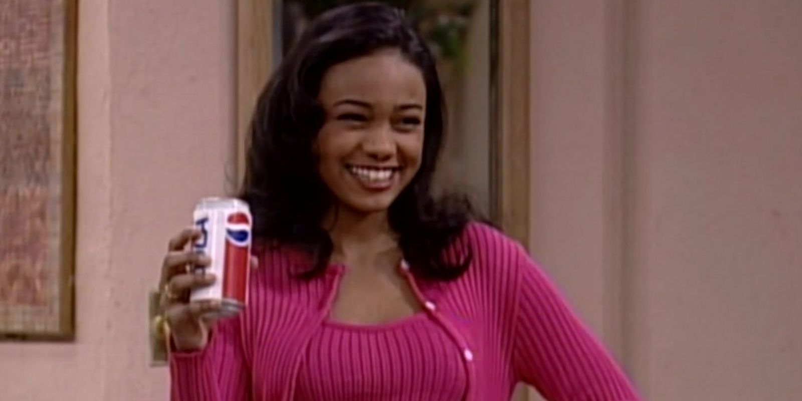 Ashley Banks poses with a soda can in the Banks living room in The Fresh Prince of Bel Air