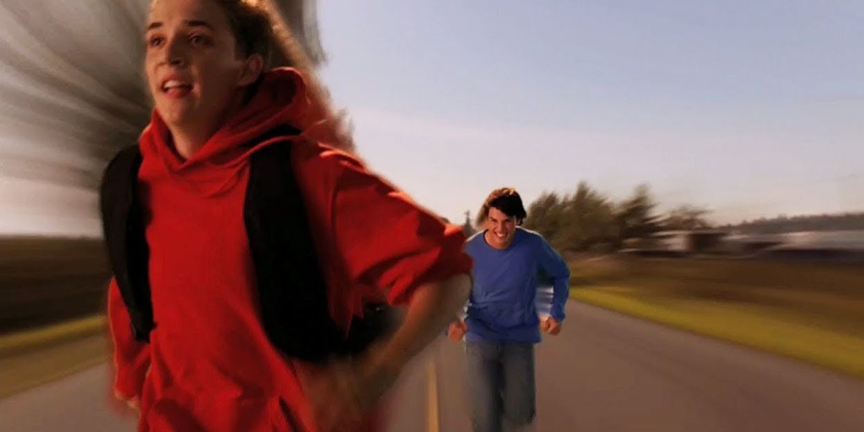 The Flash runs ahead of Clark on a road in Smallville.