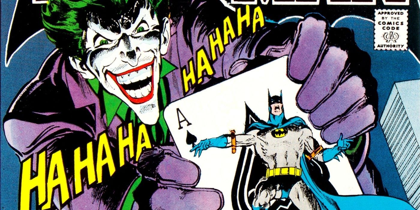 Joker laughing and holding a card with Batman on it
