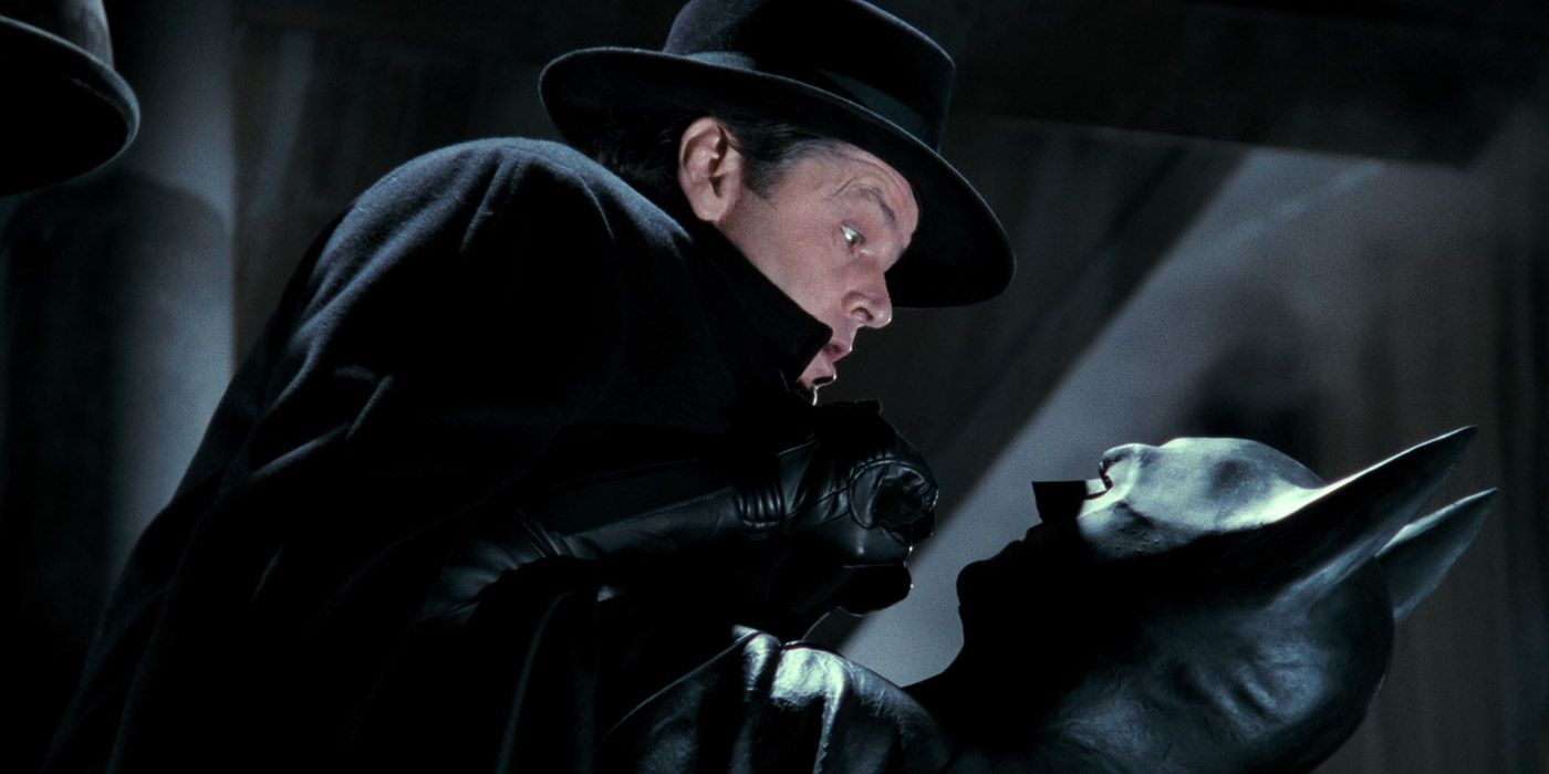 Batman lifts up Jack Napier during a sting operation in 1989's Batman