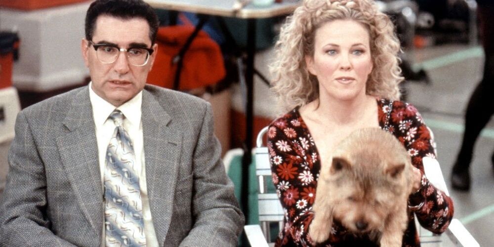 Catherine O'Hara and Eugene Levy sitting with a dog in Best in Show