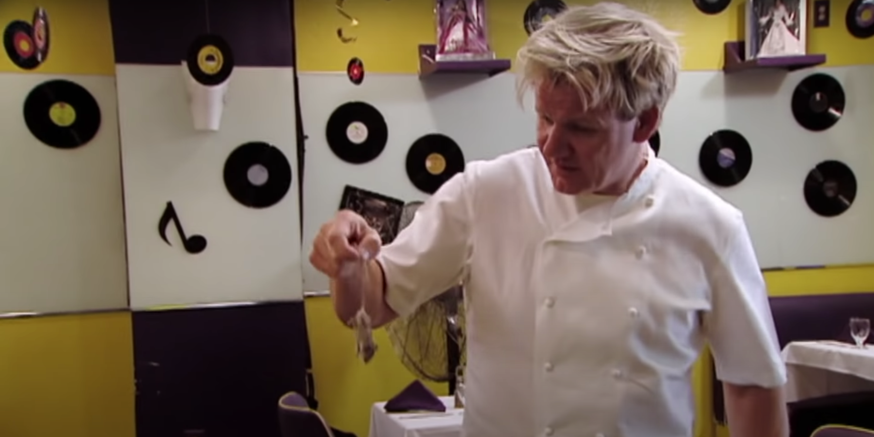 An image of Gordon Ramsay holding a dead mouse by the tail.