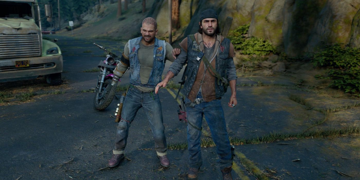 A photo of Boozer and Deacon standing next to each other in the middle of a road in Days Gone.