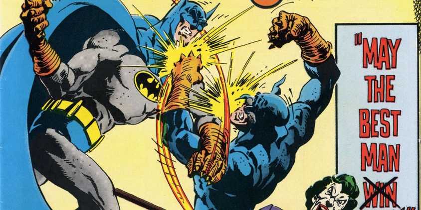 Batman fighting Wildcat in a ring while Joker cheers