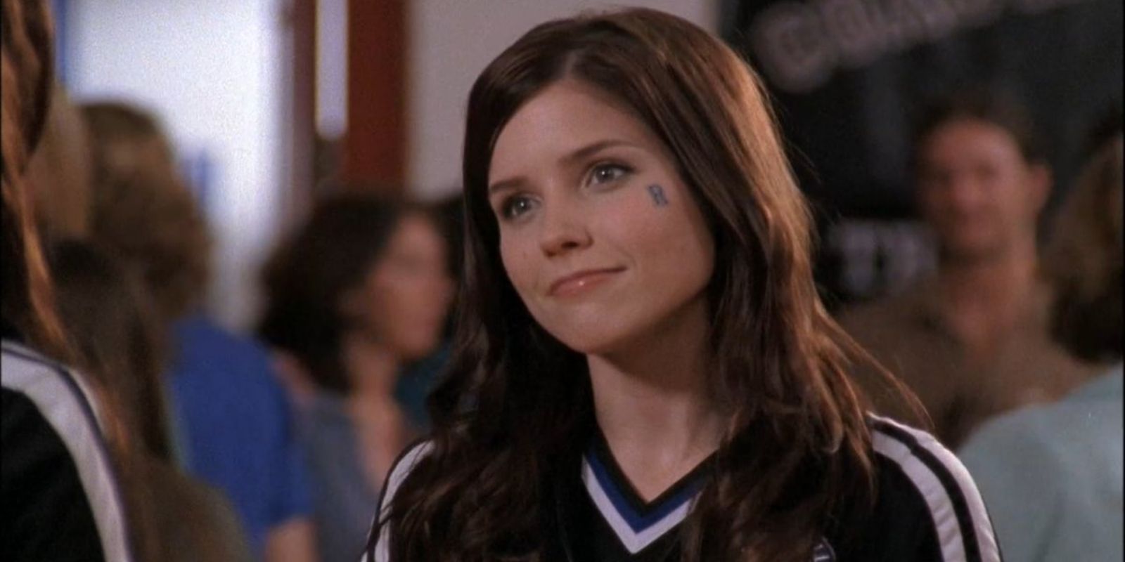 Brooke Davis smiling in her cheerleader uniform on One Tree Hill.