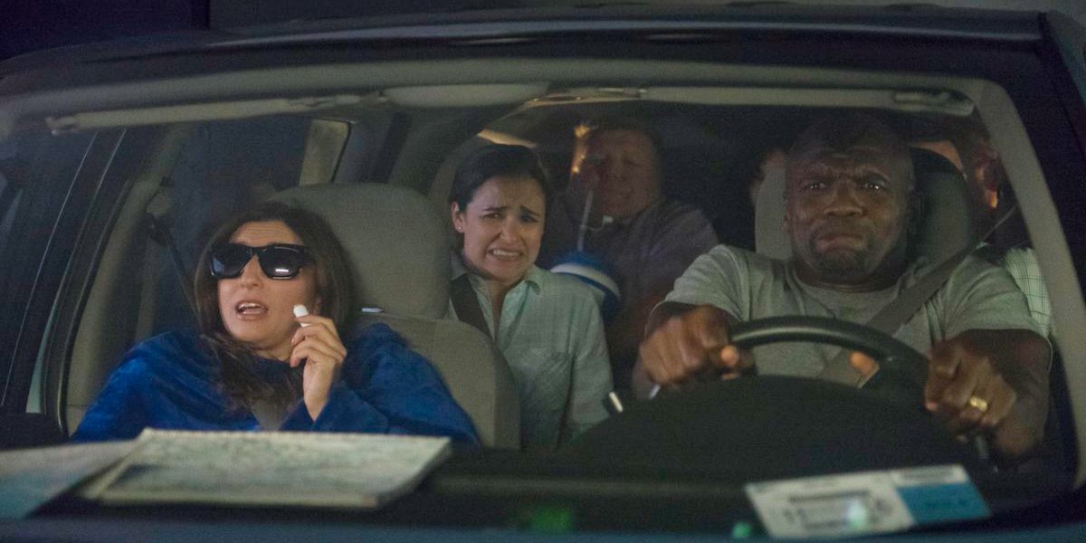 Terry, Amy, Rosa, and a man brace for impact in a car in Brooklyn 99.