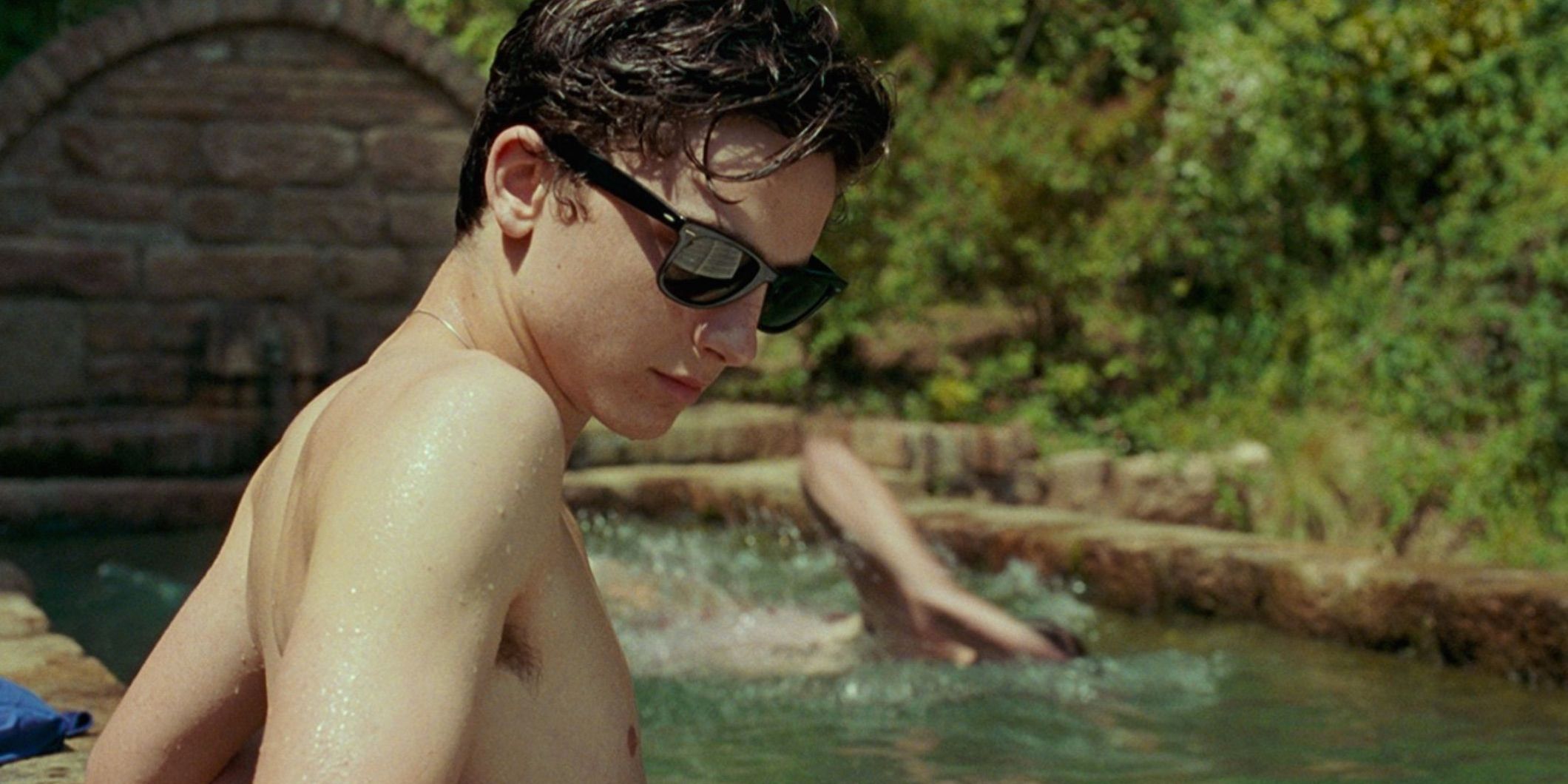Elio lounges in the pool with sunglasses in Call Me By Your Name.