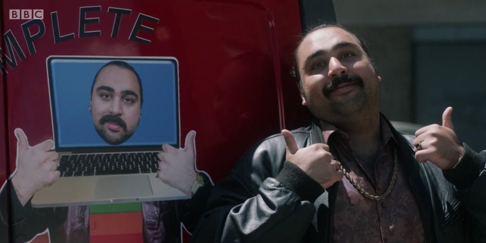 Chabuddy G standing in front of his red van in People Just Do Nothing