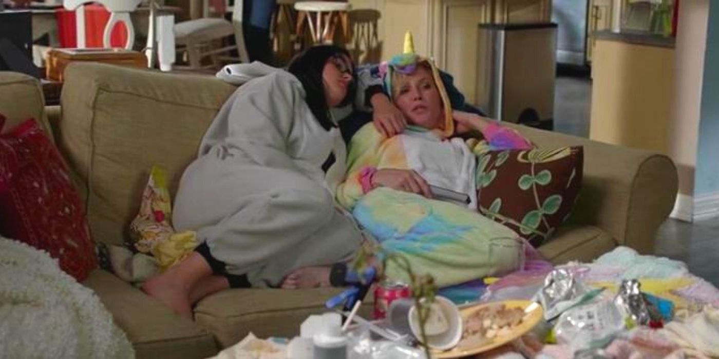 Claire and Alex lounge on the couch in costumes on Modern Family