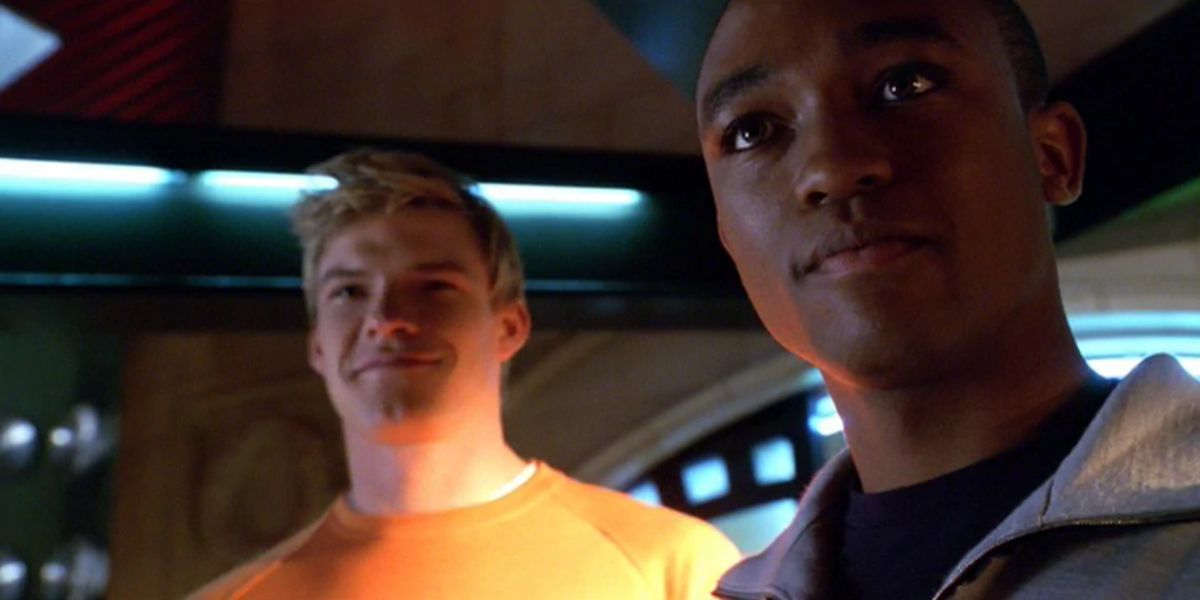 Cyborg and Aquaman smile together in a secret room in Smallville.