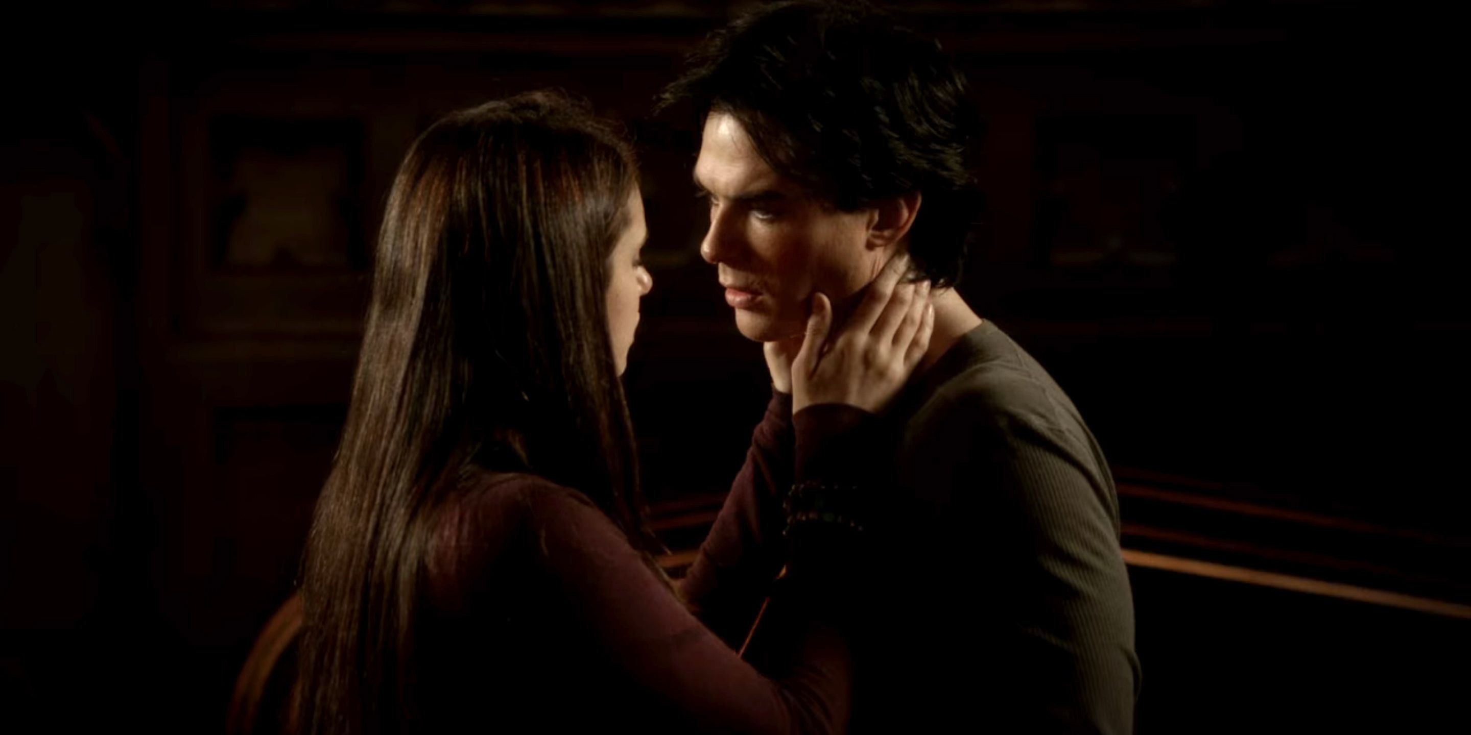 Elena holds Damon's face in The Vampire Diaries.