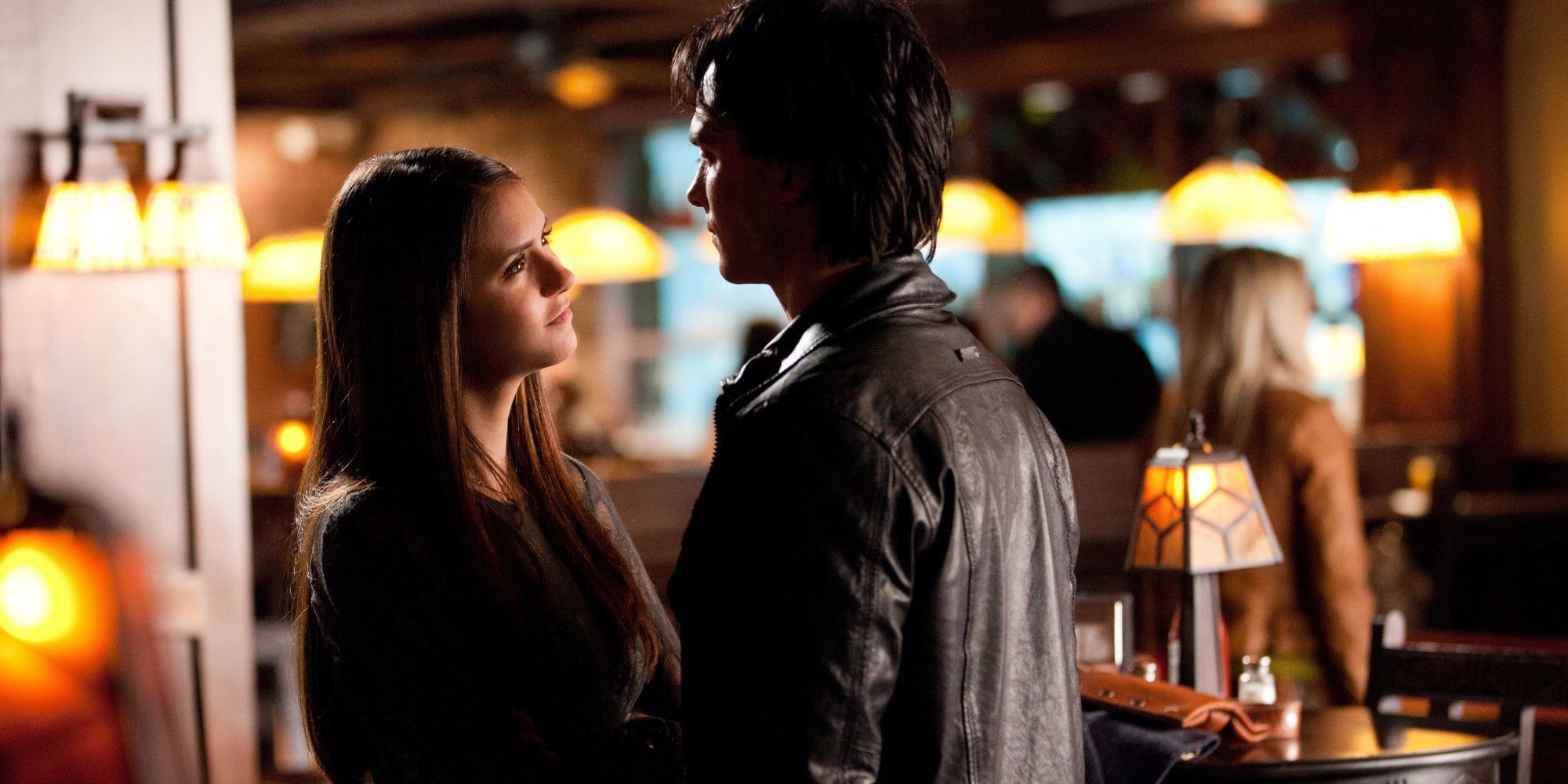 Damon and Elena talking at the bar in The Vampire Diaries.