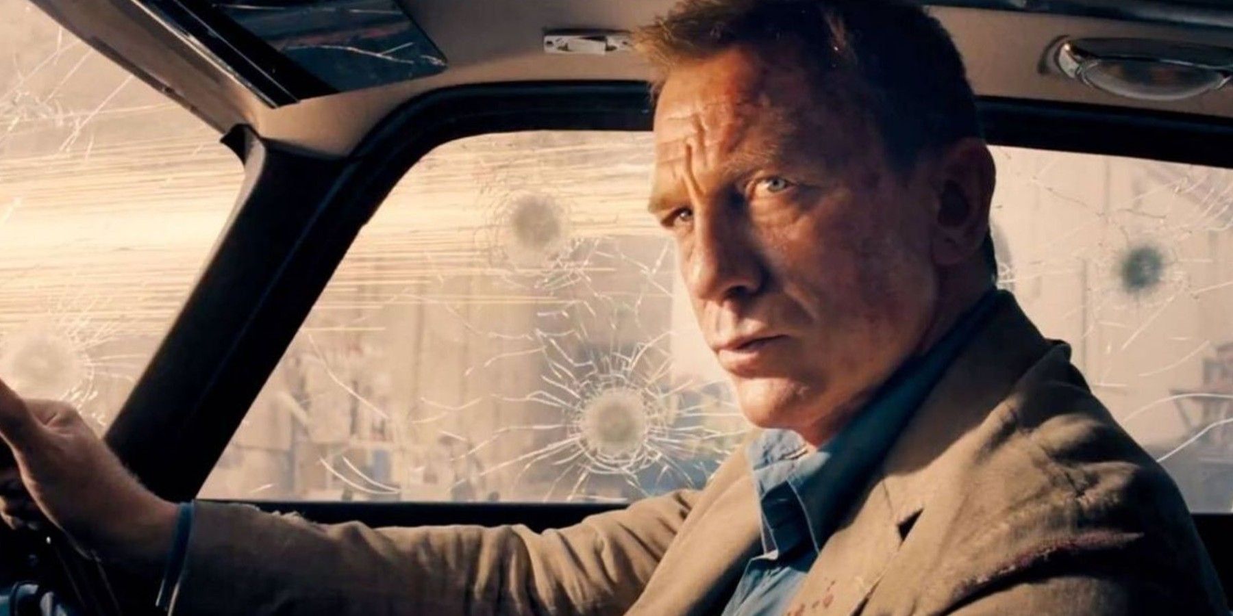 Daniel Craig sitting in a gadget-filled car in No Time To Die