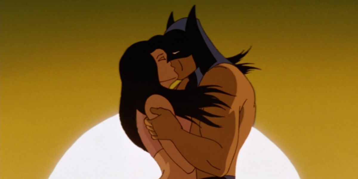 Batman shares a passionate kiss with Talia in the desert.