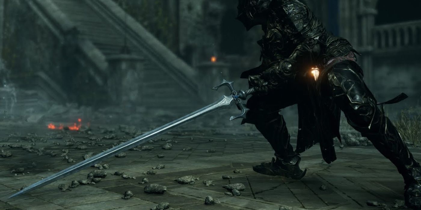 The player drags the Penetrating Sword along the stone pavement in Demon's Souls.