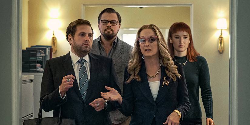 Dr. Mindy (Leonardo DiCaprio) and Kate (Jennifer Lawrence) walk behind White House Chief of Staff Jason Orlean (Jonah Hill) and US President Janie Orlean (Meryl Streep) in Don't Look Up