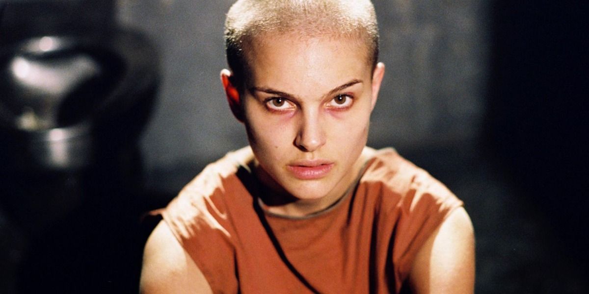 Evey from V For Vendetta with a shaved head, looking at the camera