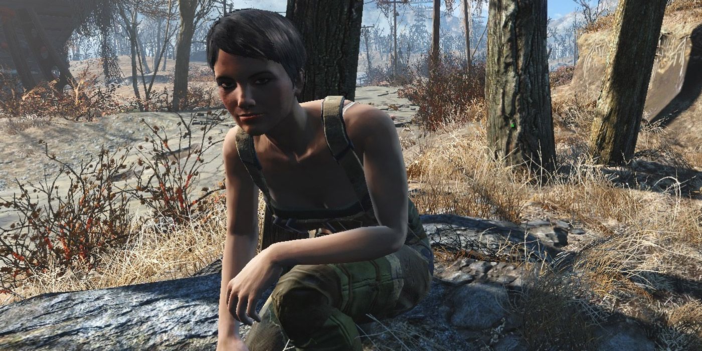 A companion down on one knee in a forest in Fallout 4