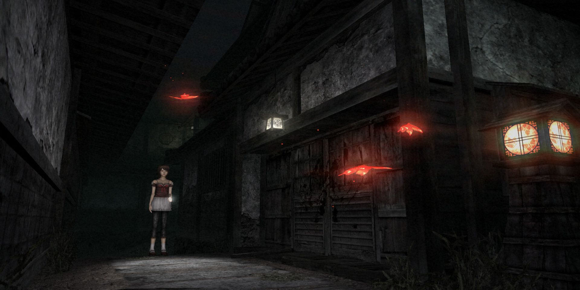 A girl shines a flashlight in a dark alley in Fatal Frame II Crimson Butterfly.