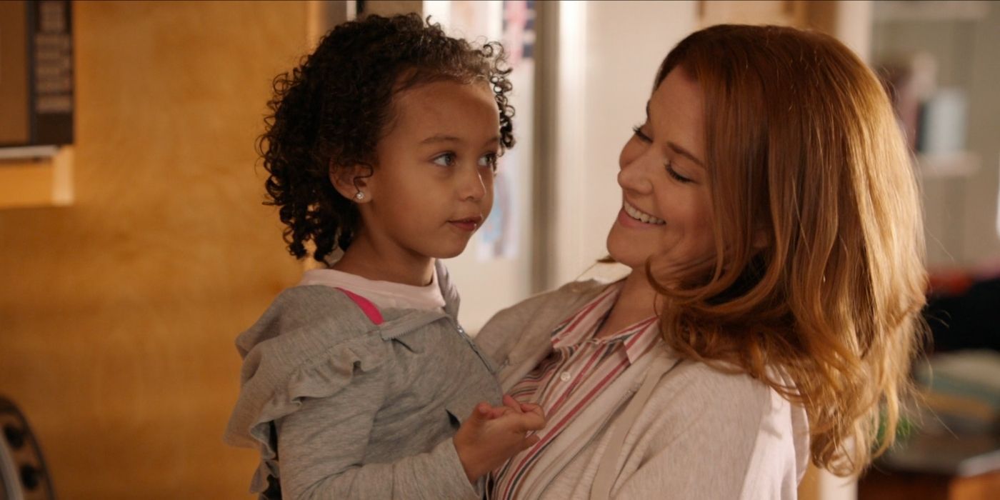 April carries baby Harriet and smiles in Grey&rsquo;s Anatomy.