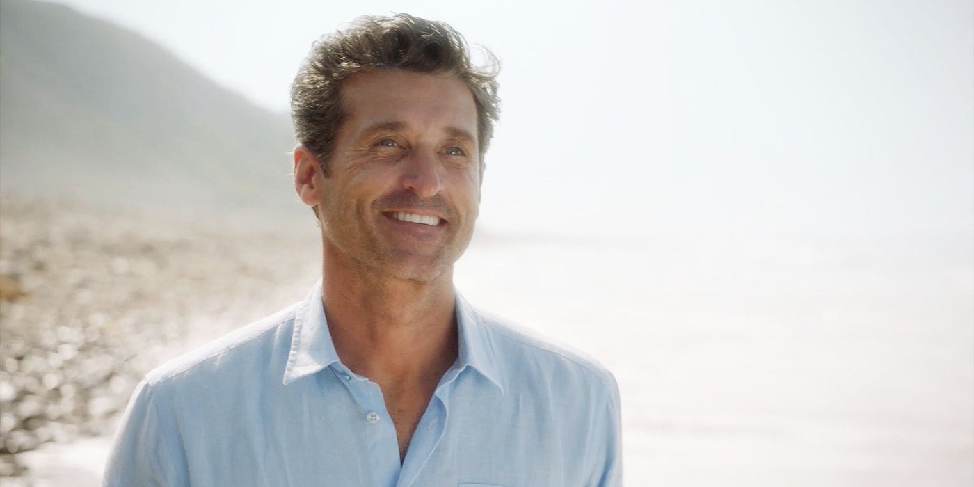 Derek smiling while standing on the beach in Grey's Anatomy