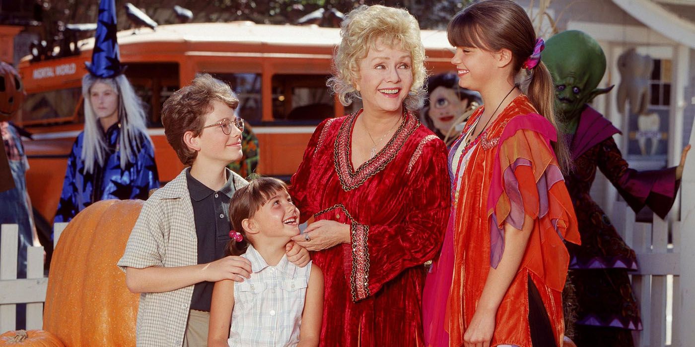 Image of the main cast standing outside in Halloweentown.