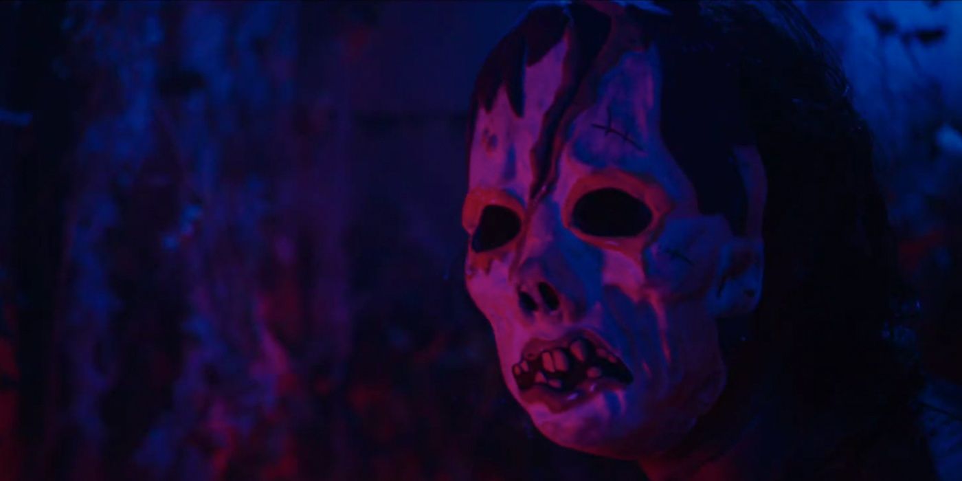 The zombie masked killer under a blacklight from Haunt