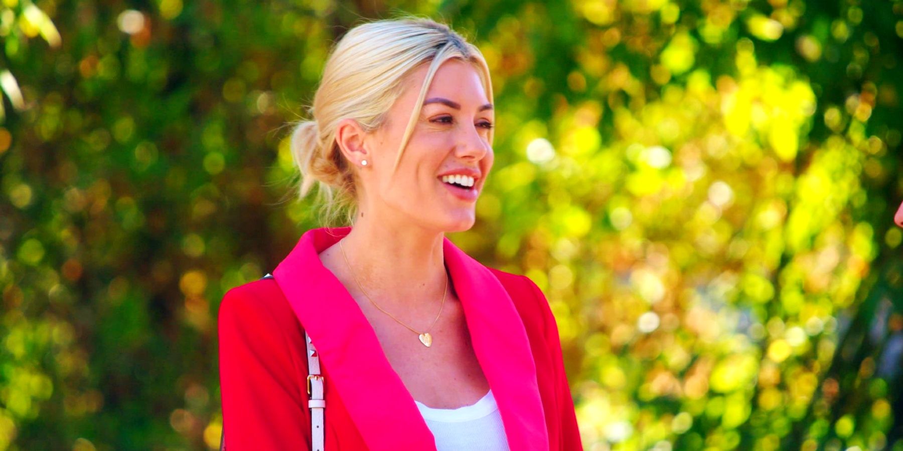 Heather Rae Young smiling outside on Selling Sunset